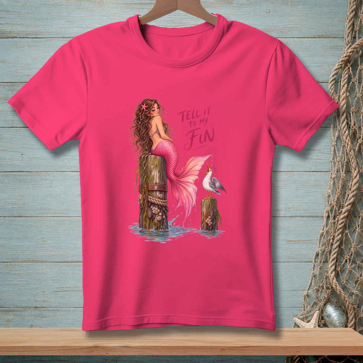 Pink t-shirt with mermaid and seagull graphic with text "Tell it to my Fin."