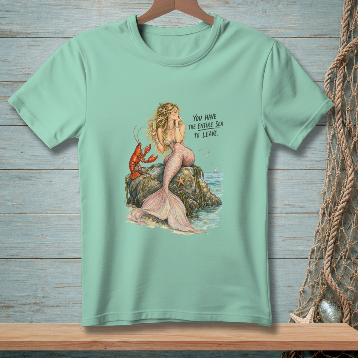 Mint t-shirt with illustration of a mermaid and lobster, text "You have the entire sea to leave."