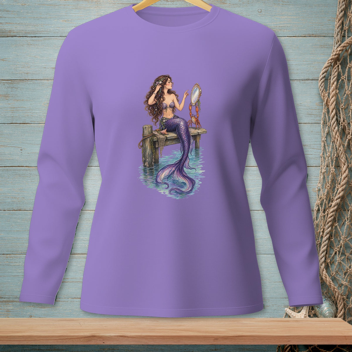 Mermaid sitting on a pier, holding a mirror, with a crab on a purple long-sleeve shirt.