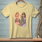 Two mermaids sit on rocks, one holding a shell, the other pouring trash from her lap.