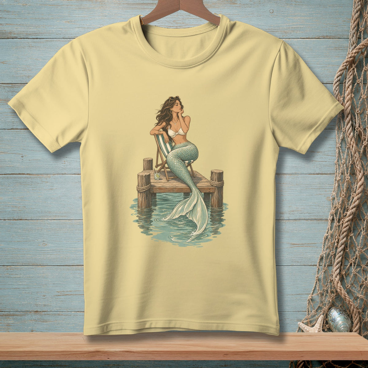 Mermaid sitting on a wooden dock with a striped chair and water reflections.
