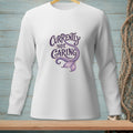 White long-sleeved shirt with "Currently Not Caring" and mermaid tail graphic.