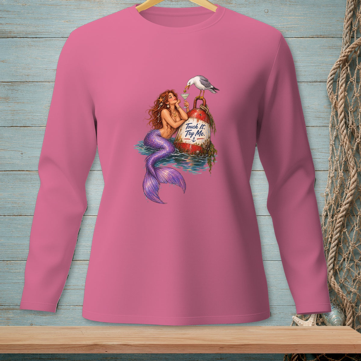 Pink long-sleeve shirt with mermaid, buoy, and seagull design.