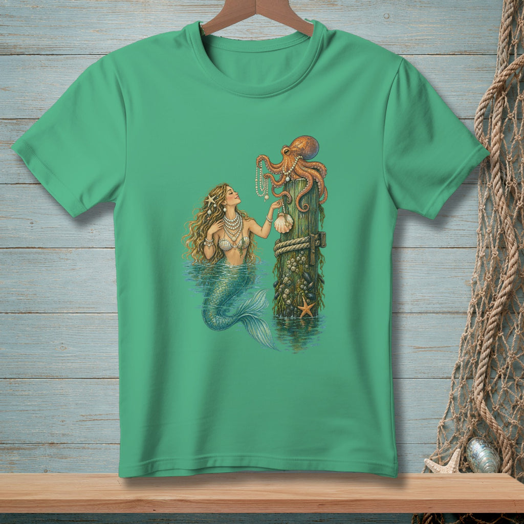 Green t-shirt with a mermaid and octopus illustration on a wooden post.