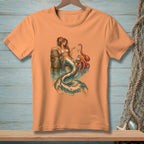 Mermaid and octopus illustration on an orange t-shirt.