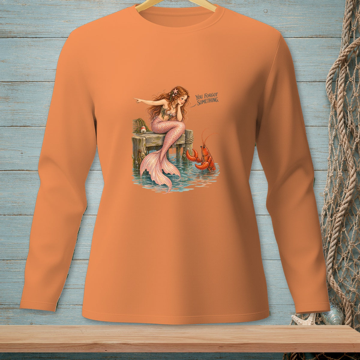 Mermaid on dock with lobster and text "You Forgot Something."