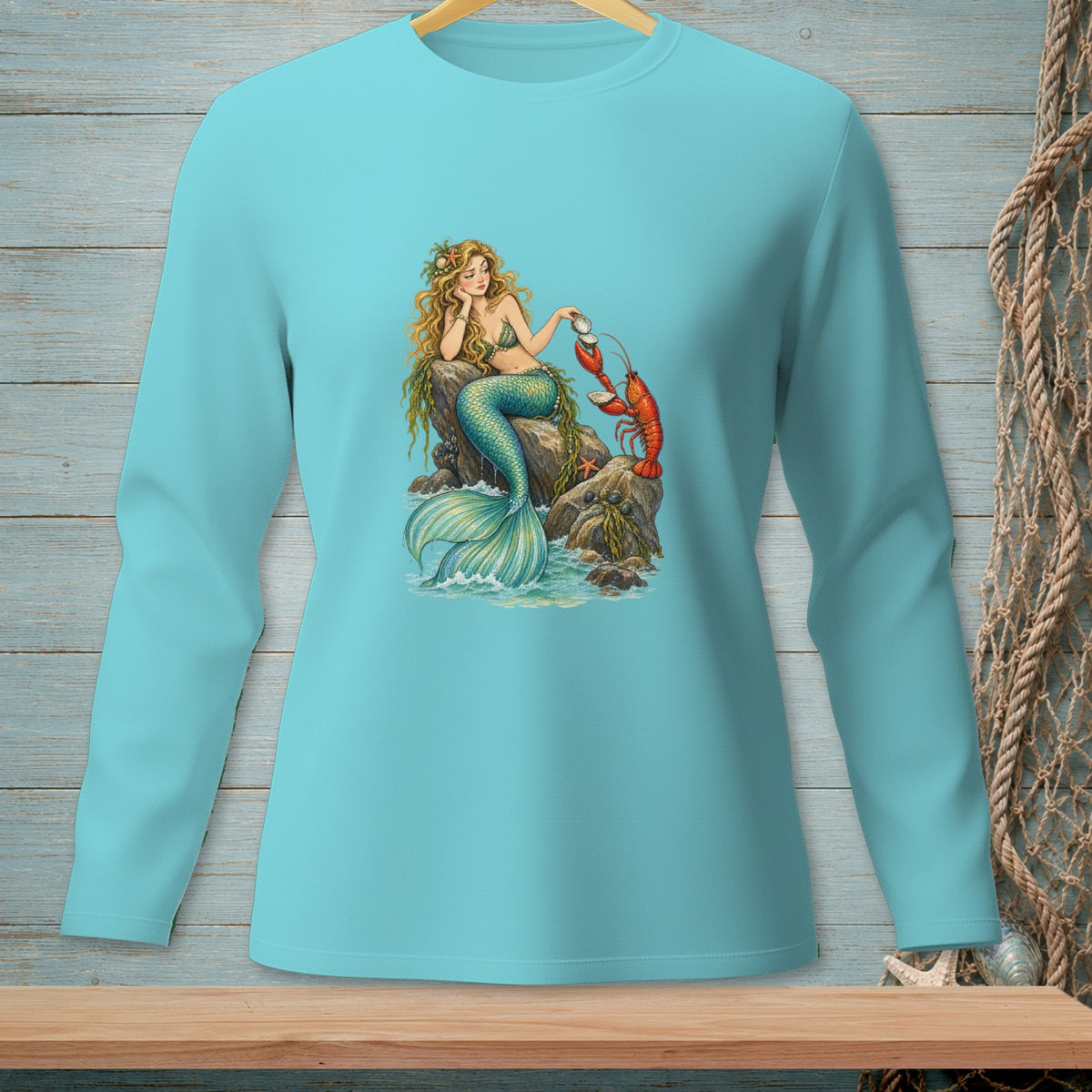 Mermaid with lobster on rocks, illustration on a blue long-sleeve shirt.