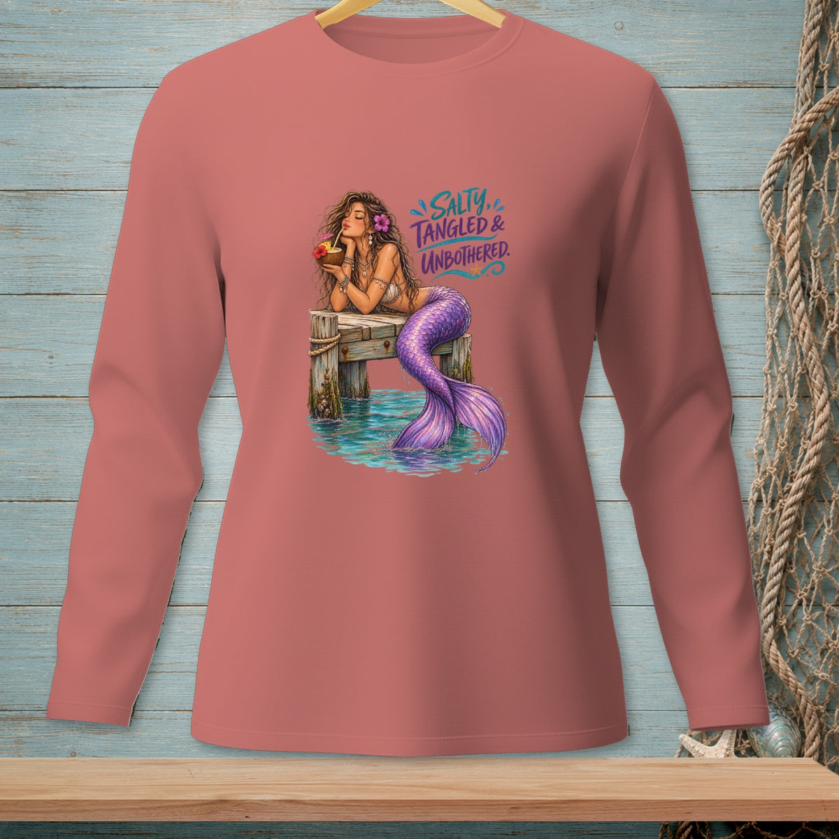 Long-sleeve shirt with mermaid illustration and text "Salty. Tangled & Unbothered."