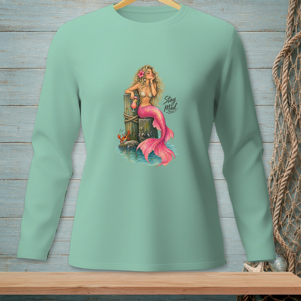 Mermaid with pink tail and drink, sitting on a post, with text "Stay Mad."