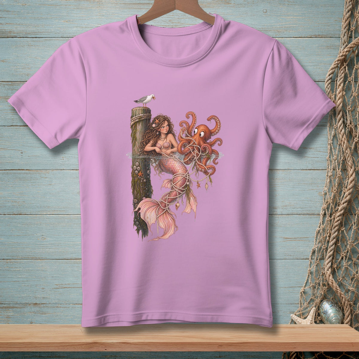 Mermaid and octopus artwork on a light purple t-shirt with nautical background.