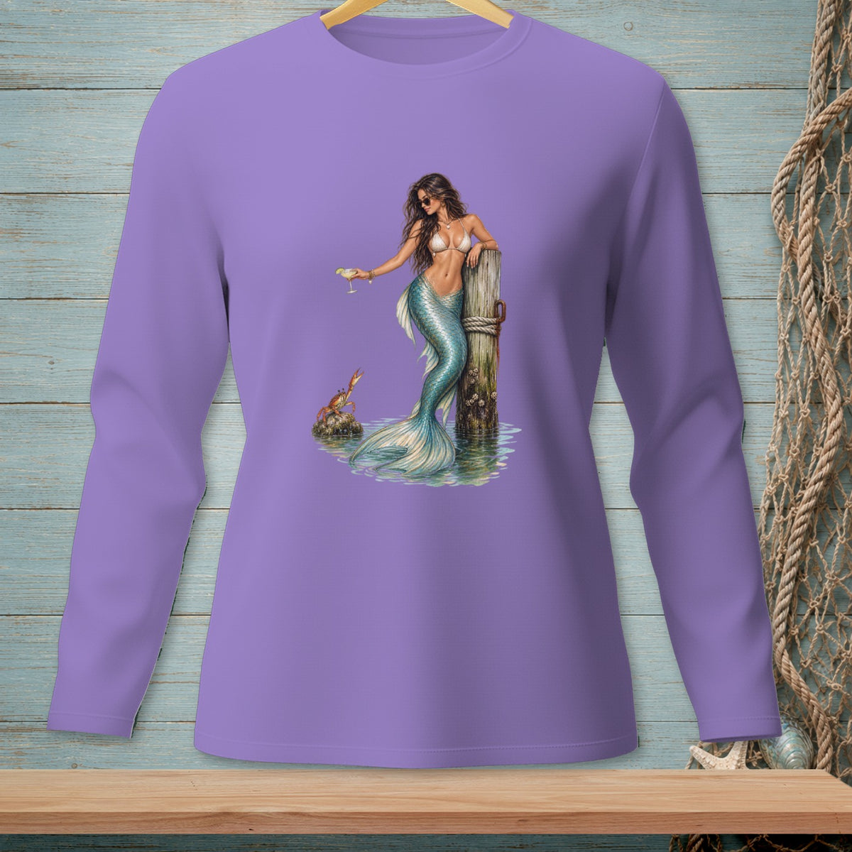 Mermaid with drink rests on post near crab, on a purple long-sleeve shirt.
