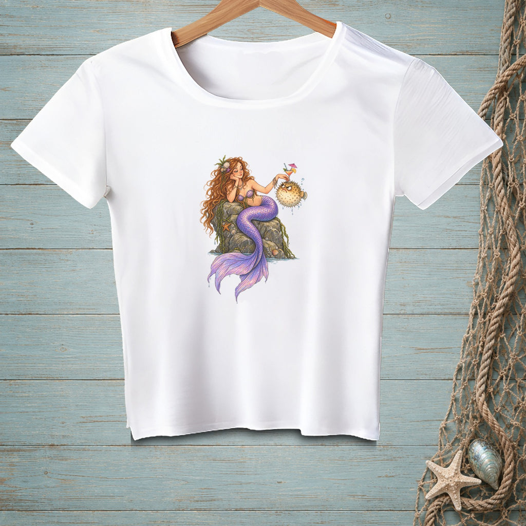 White t-shirt featuring a cartoon mermaid holding a pufferfish with a cocktail.