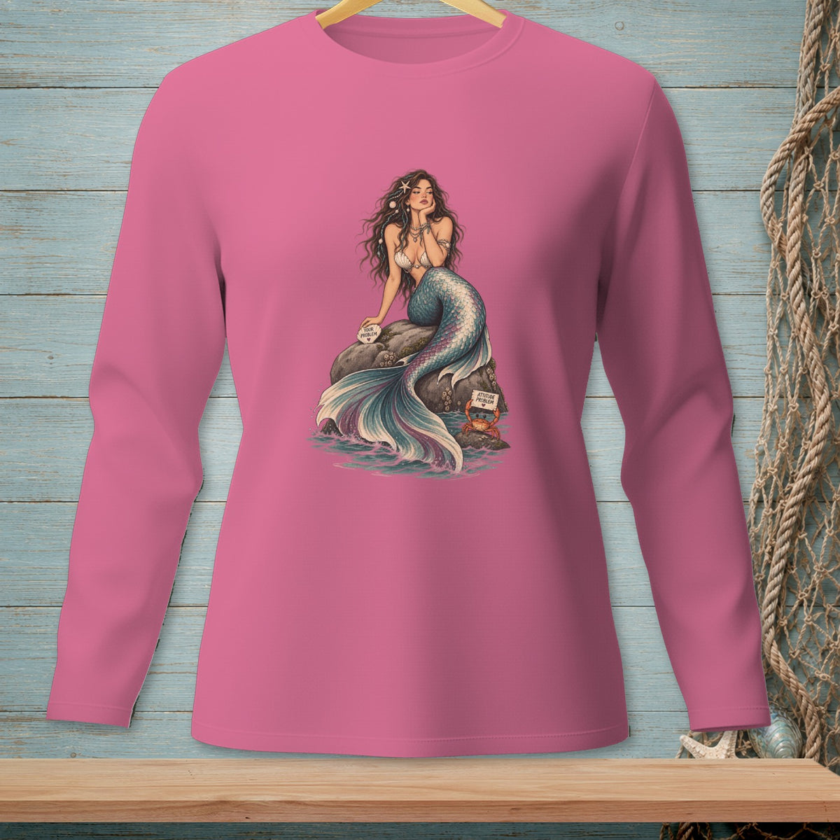 Pink long-sleeve shirt with mermaid graphic and "Attitude Problem" sign.