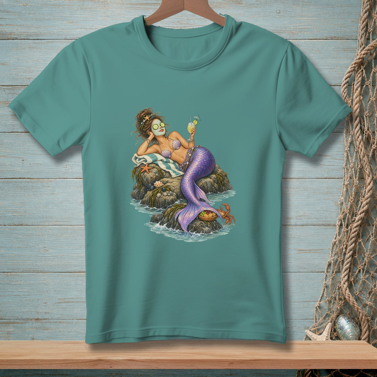 Mermaid with cucumber eyes, seashell bikini, and drink relaxes on rocks.