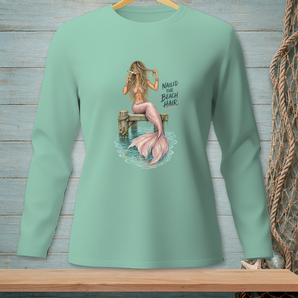 Mint green long-sleeve shirt with a mermaid graphic and the text "Nailed the Beach Hair".