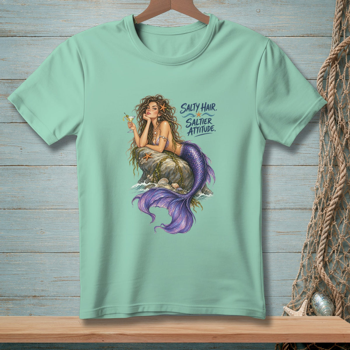 Mint t-shirt with a mermaid illustration and the text "SALTY HAIR. SALTIER ATTITUDE."