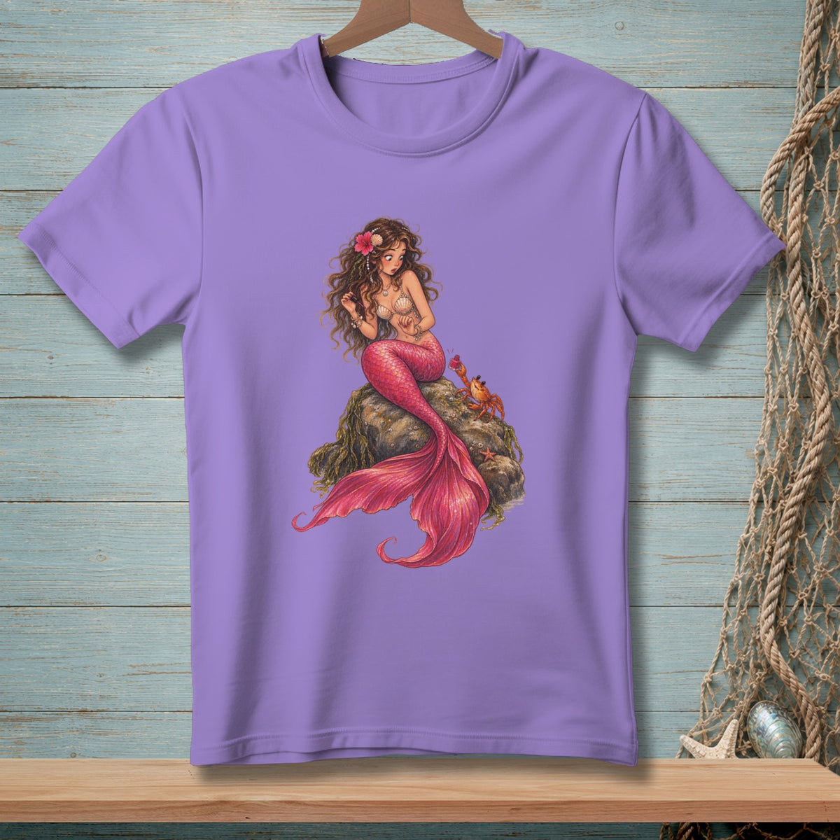 Purple t-shirt featuring a drawing of a mermaid on a rock with a crab.