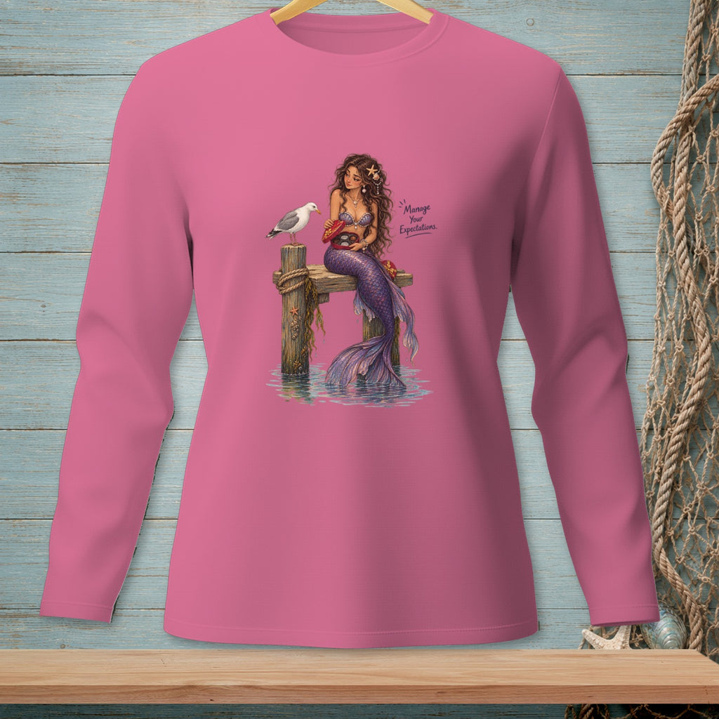 Pink long-sleeve shirt with a mermaid and seagull, featuring text "Manage Your Expectations."