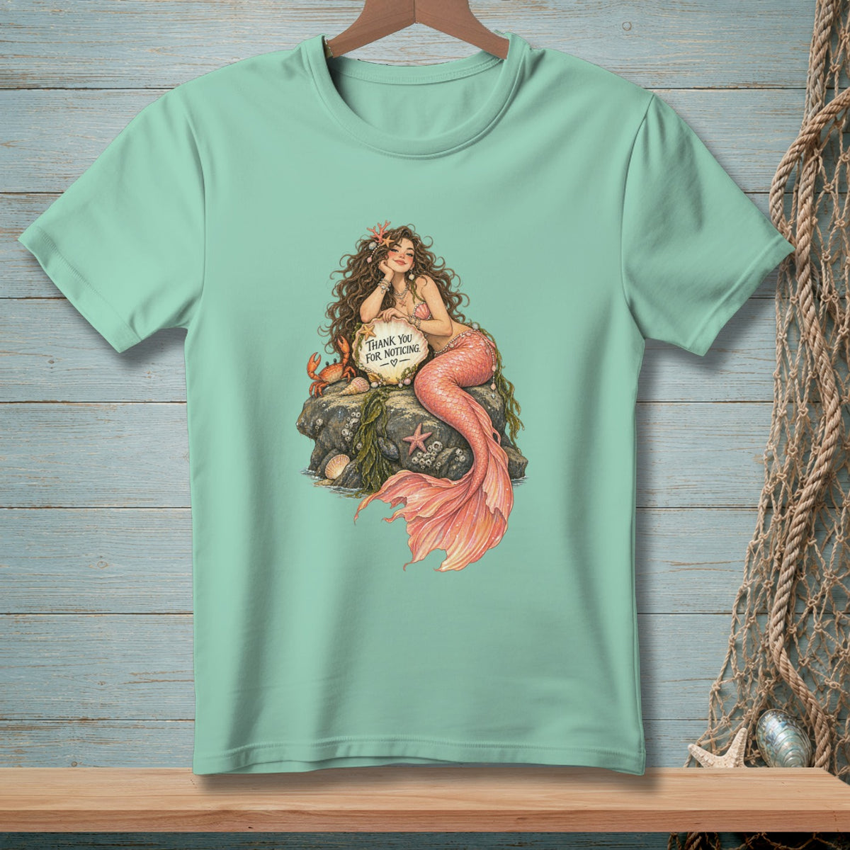 Mermaid on a rock with crab and sign saying "Thank You For Noticing".