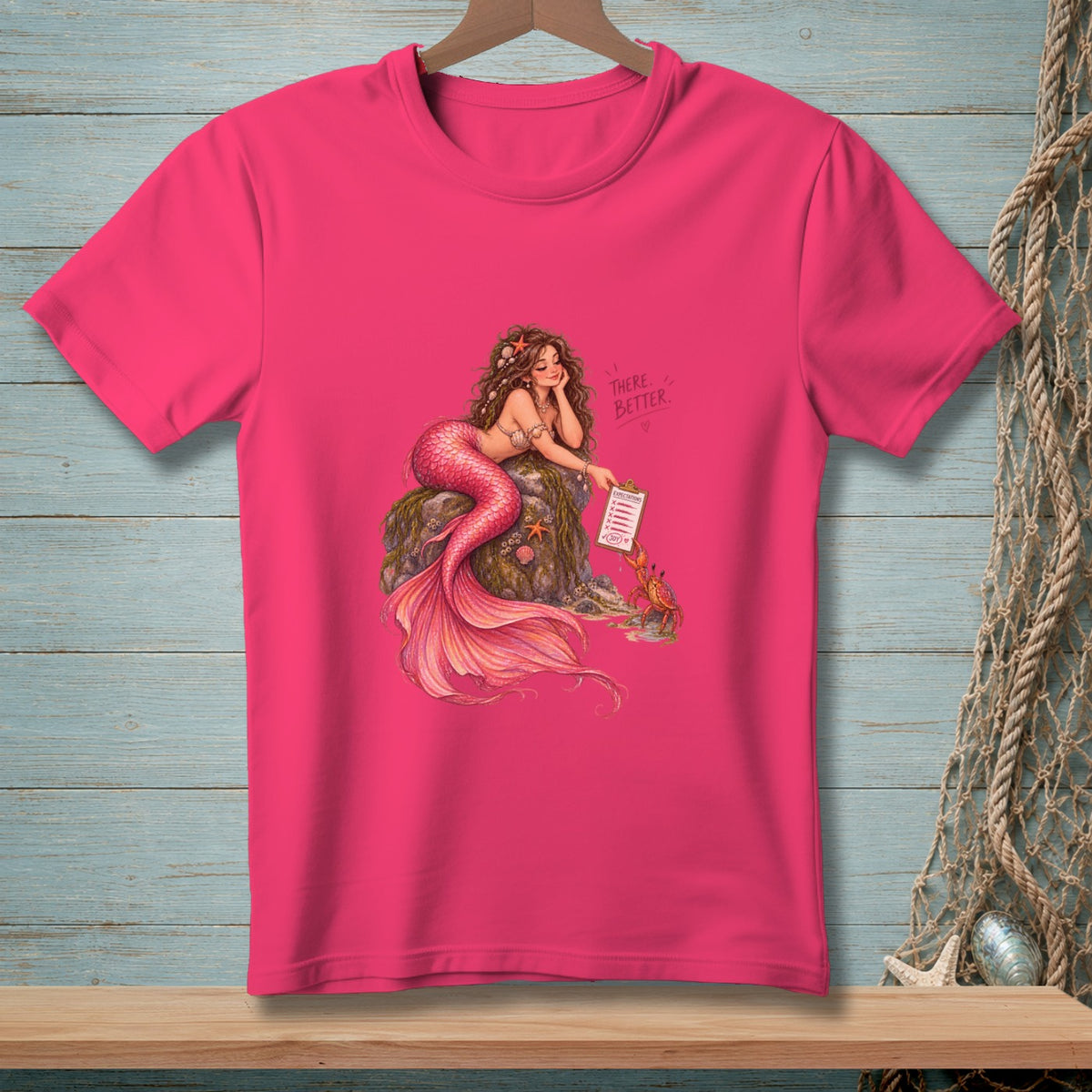 Pink t-shirt with a mermaid illustration holding a clipboard that reads "Expectations."