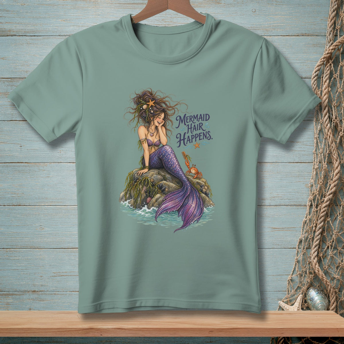 Mermaid with purple tail on rock, with "Mermaid Hair Happens" text.
