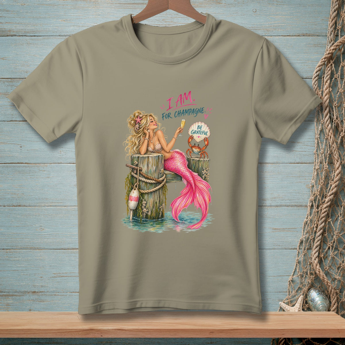 Mermaid on pier with champagne glass and crab reads "I AM FOR CHAMPAGNE. BE GRATEFUL."