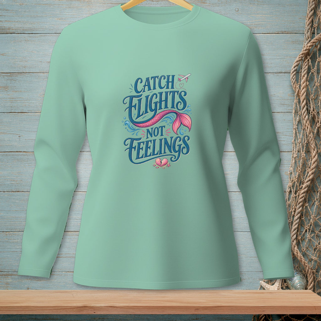 Mint green long sleeve shirt with "Catch Flights Not Feelings" mermaid tail graphic.