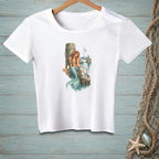 White t-shirt with mermaid on dock with crab and sailboats in background.