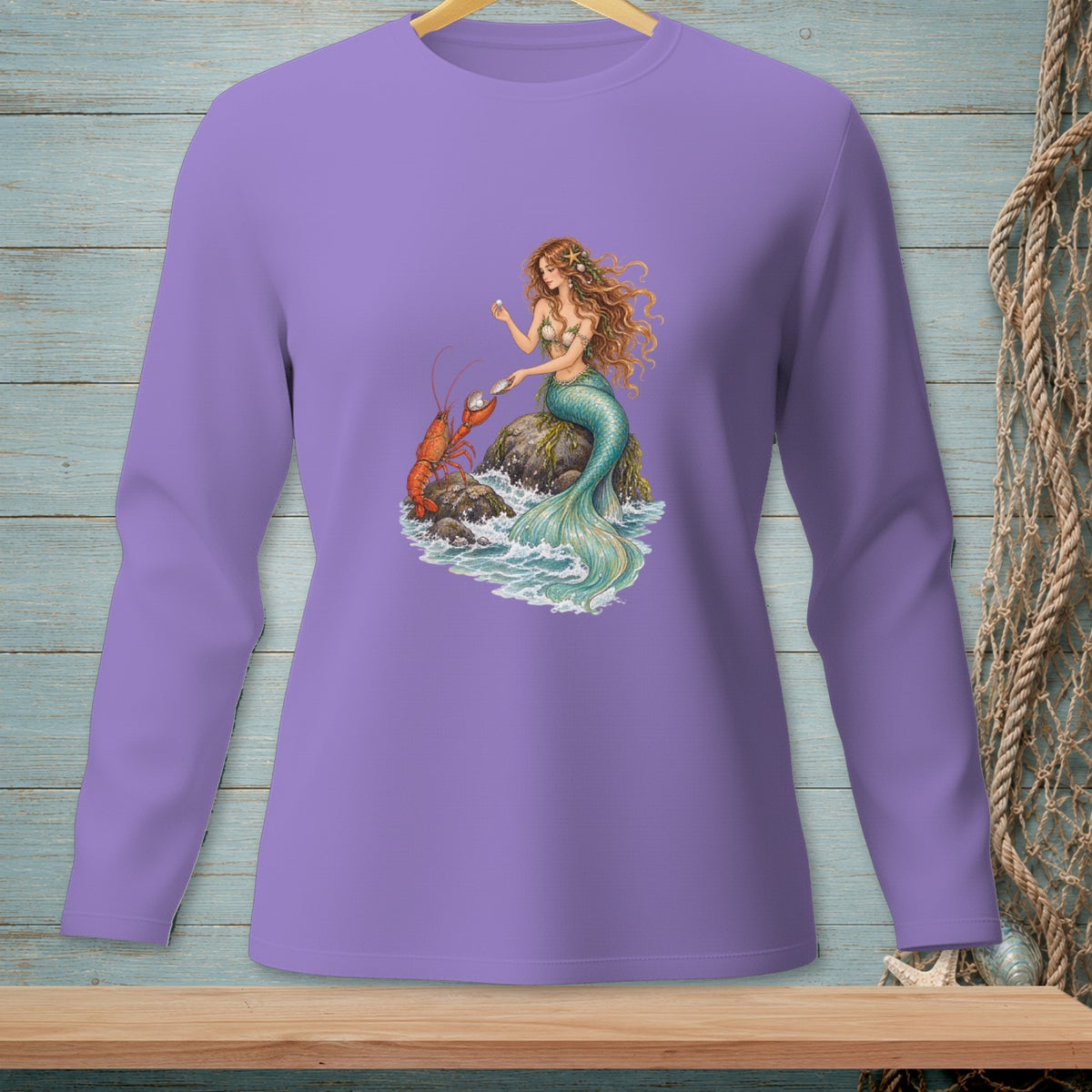Mermaid and lobster on rocks with waves, graphic on purple long-sleeve shirt.