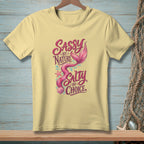 Light yellow t-shirt with mermaid design and text "Sassy by Nature Salty by Choice".