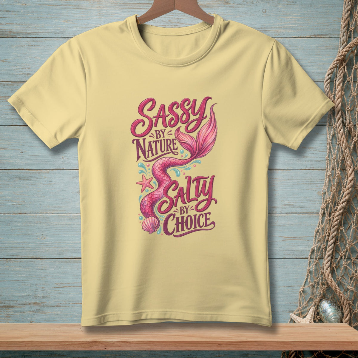Light yellow t-shirt with mermaid design and text "Sassy by Nature Salty by Choice".
