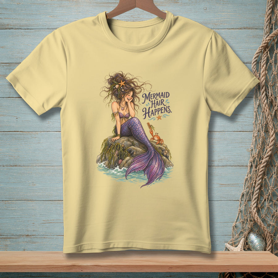 Light yellow t-shirt with a mermaid and crab graphic and text "Mermaid Hair Happens."