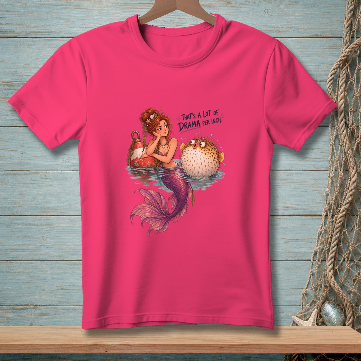 Mermaid with pufferfish and buoy, with text "That's a lot of drama per inch."