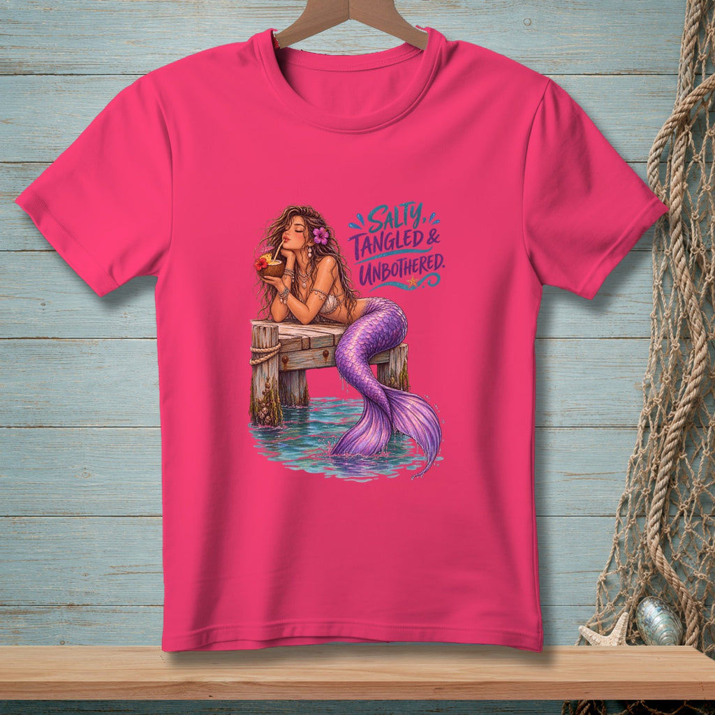 Pink t-shirt with mermaid on dock, text "Salty, Tangled & Unbothered."