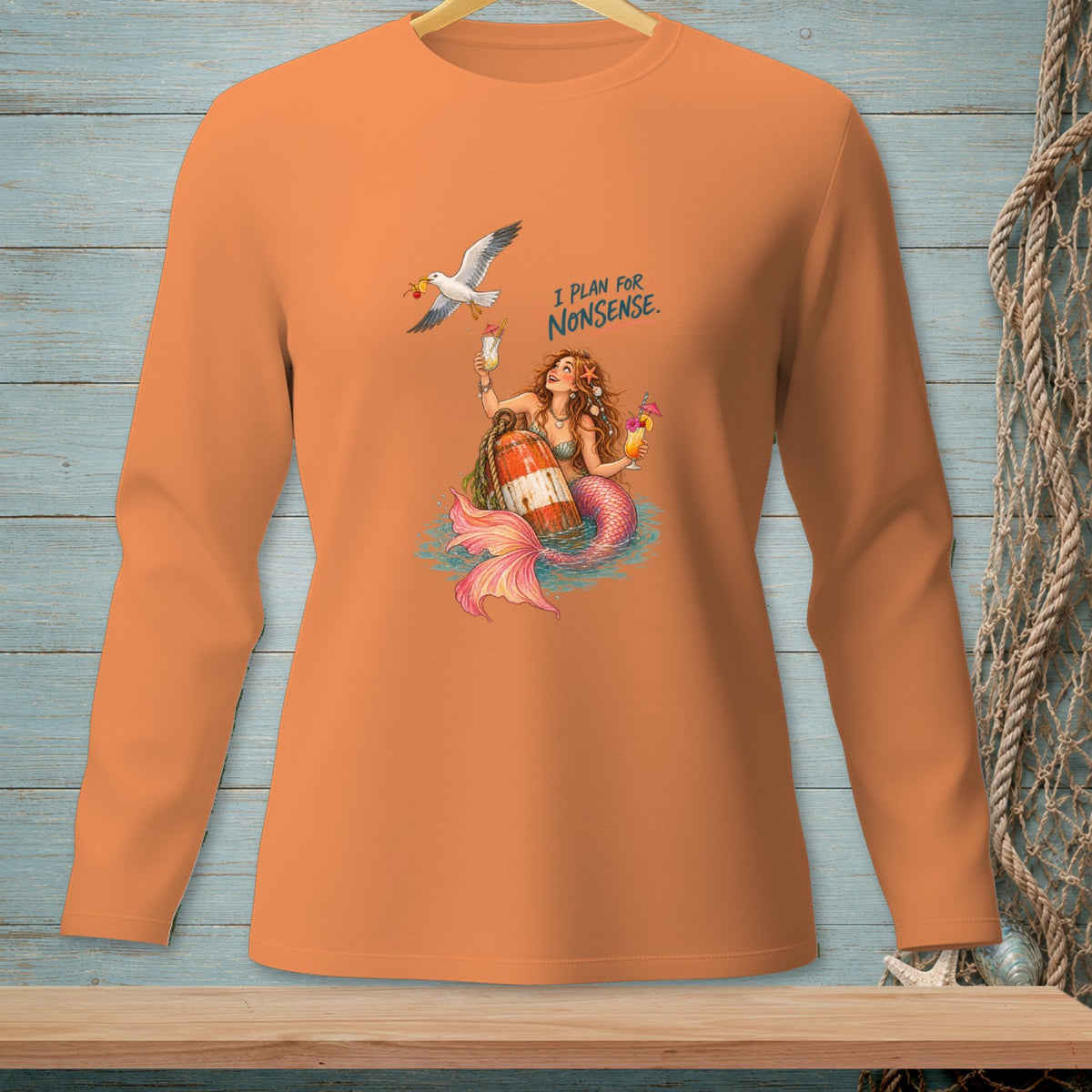 Orange long-sleeve shirt with a mermaid, drinks, and seagull graphic that reads "I PLAN FOR NONSENSE."