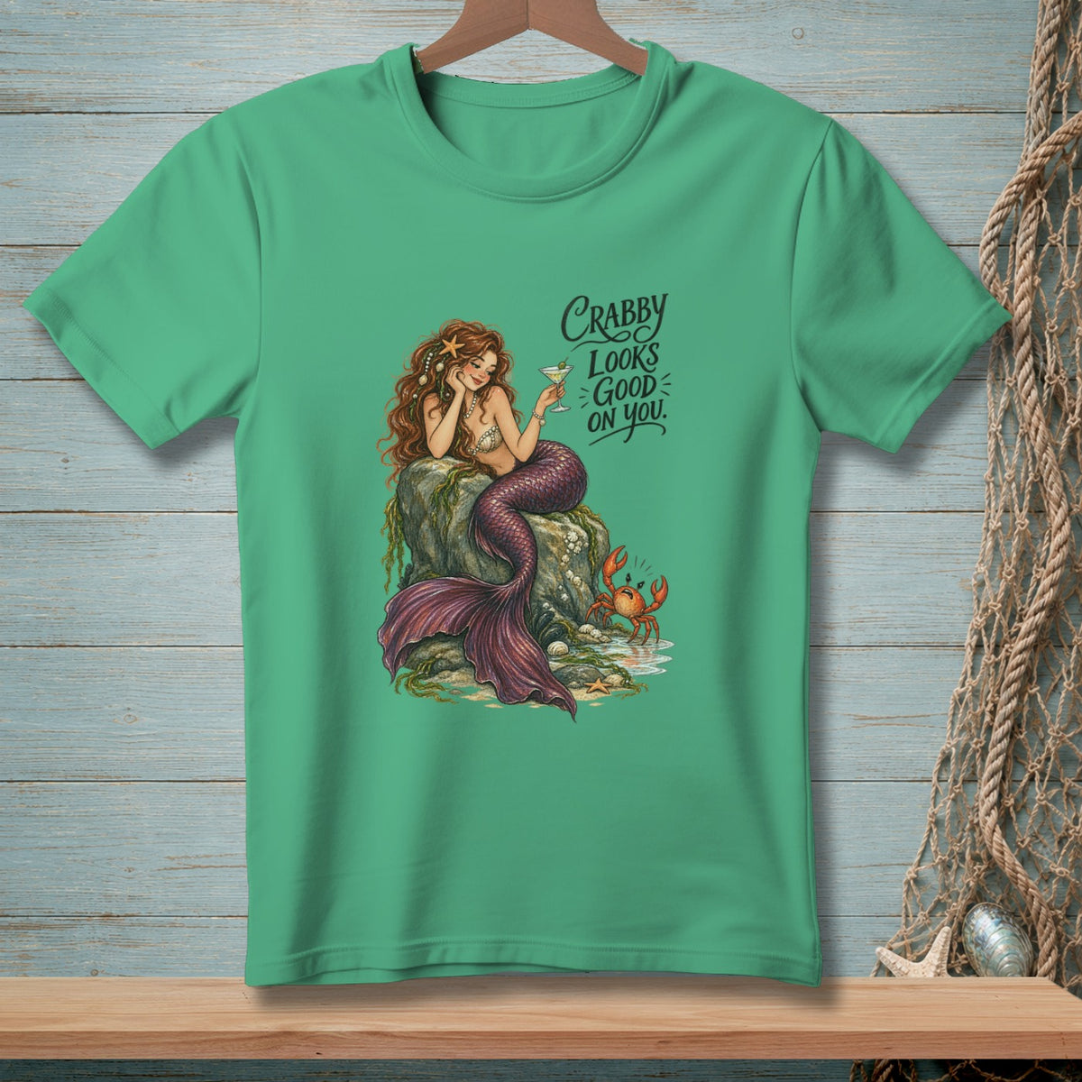 Mermaid with a drink and crab, text reads "Crabby Looks Good On You."