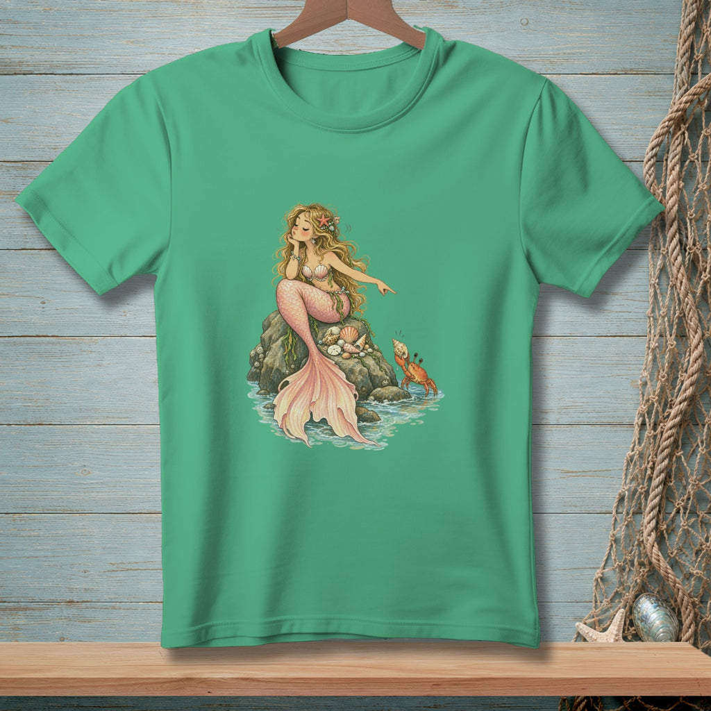 Mermaid with pink tail sits on a rock with shells and a crab.