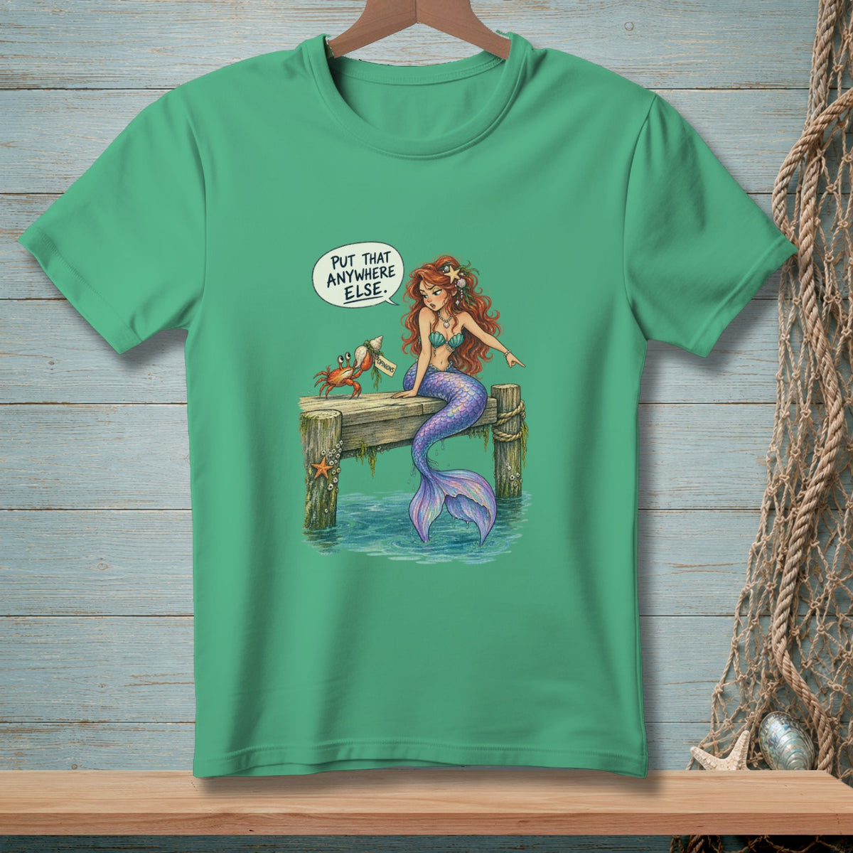 Green t-shirt with a mermaid and crab on a dock, saying "Put that anywhere else."