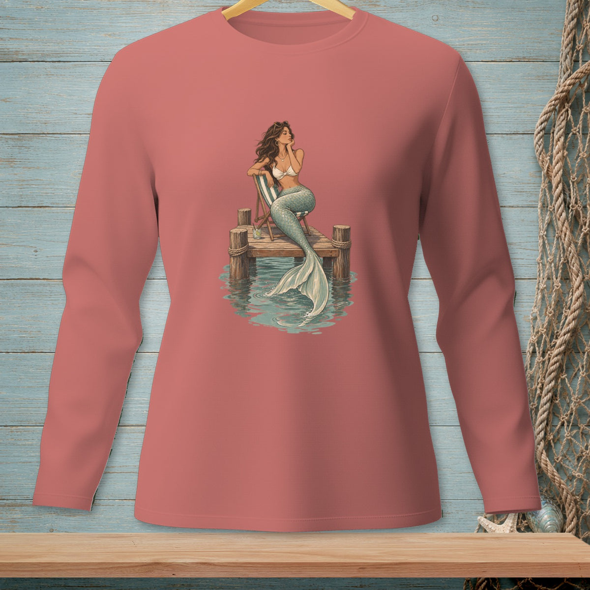 Mermaid on a pier, seated on a chair, with a tail in the water.