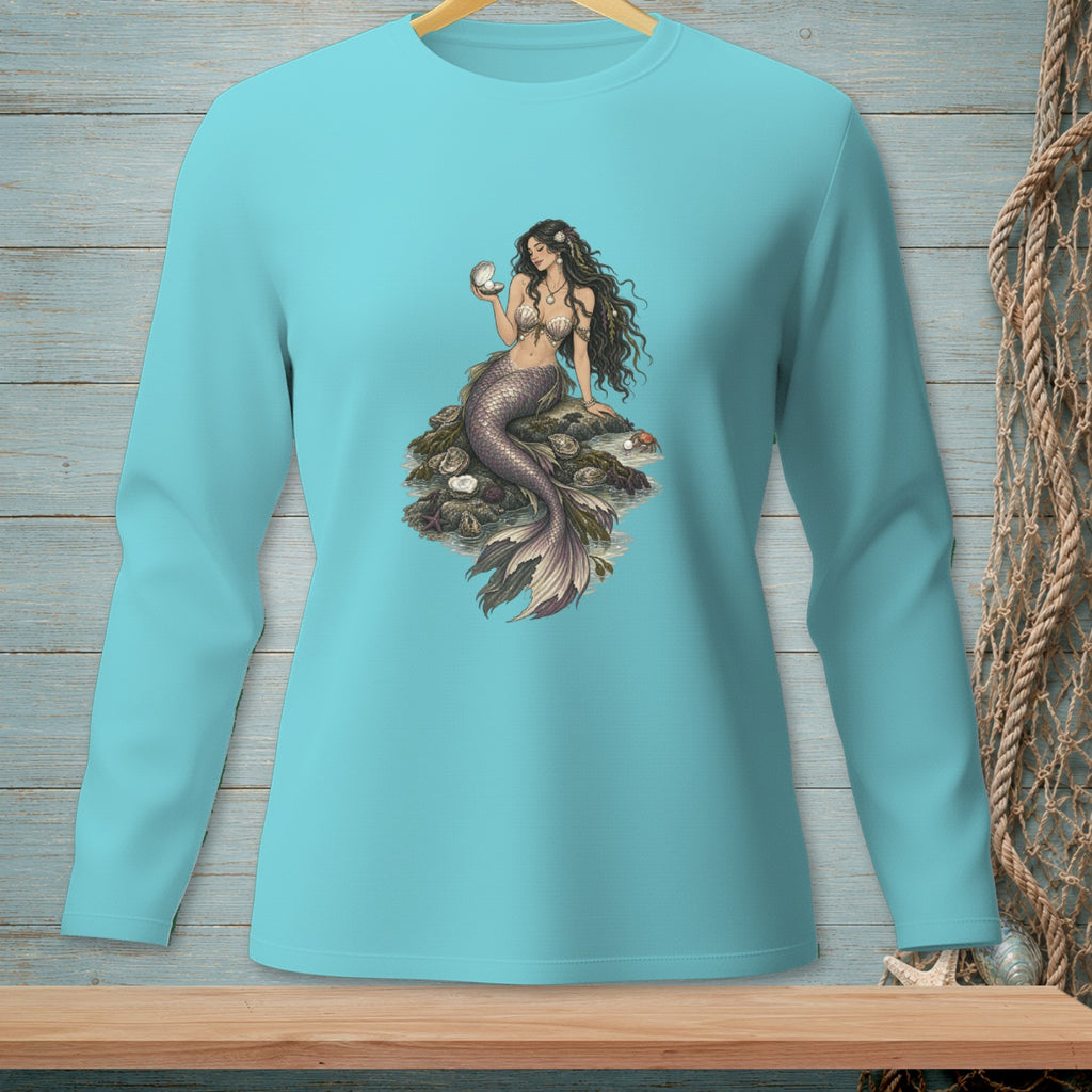 Mermaid with pearl sitting on rocks, on a blue long-sleeve shirt.
