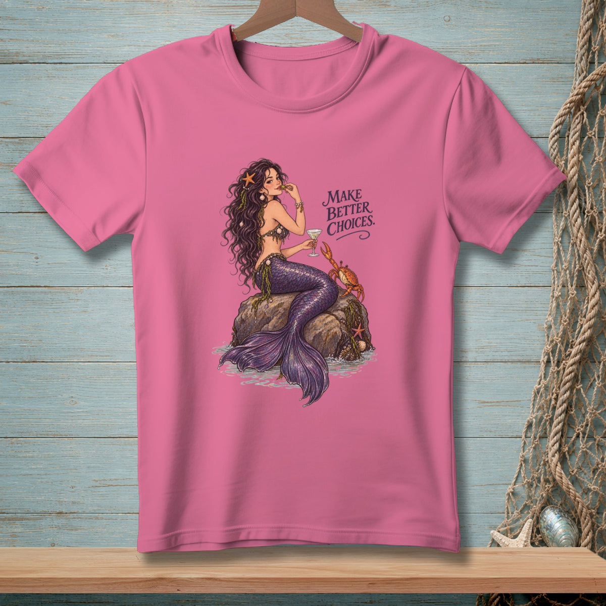 Pink t-shirt with a mermaid sitting on a rock, holding a drink, with text "Make Better Choices."
