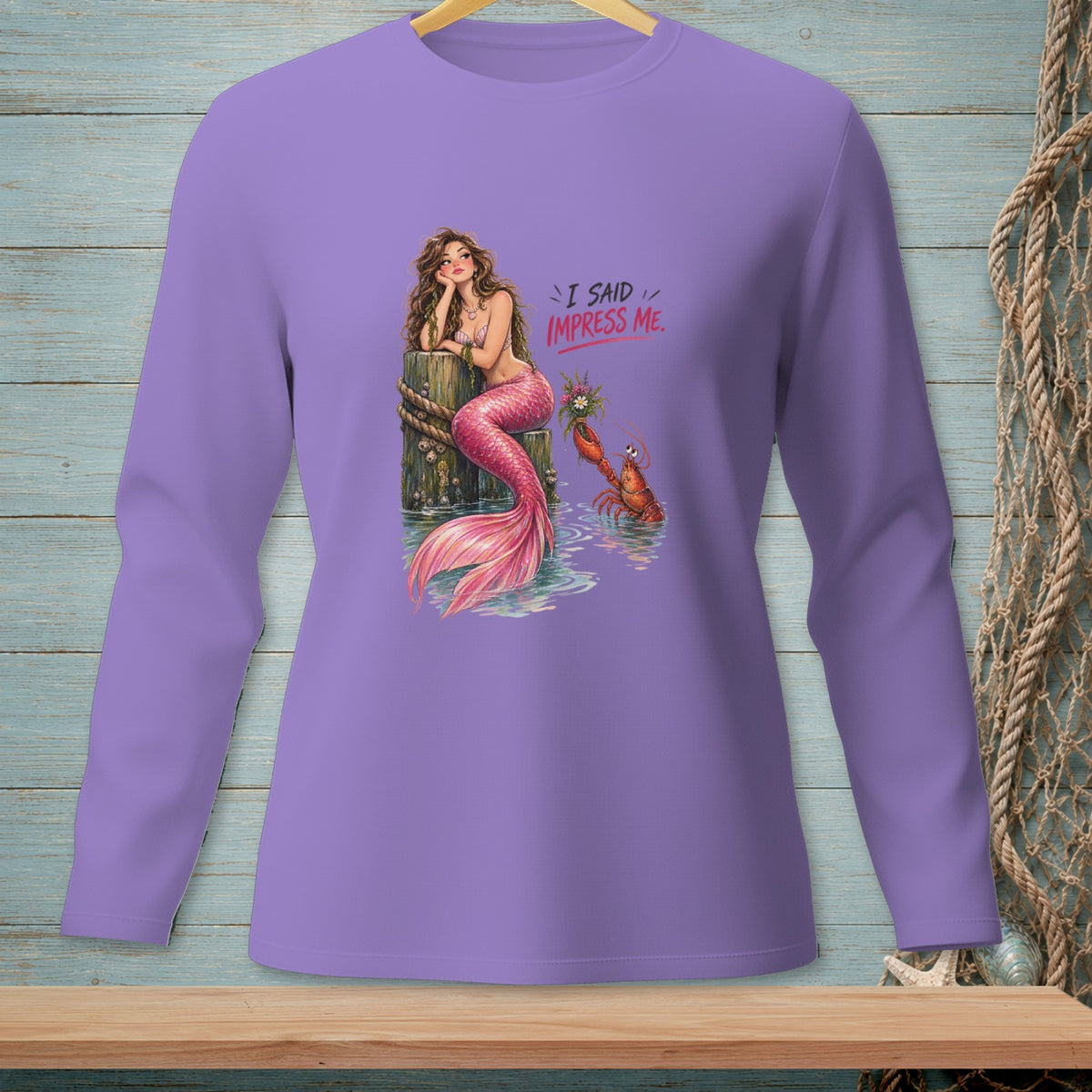 Mermaid with pink tail and lobster on pier, text "I SAID IMPRESS ME."