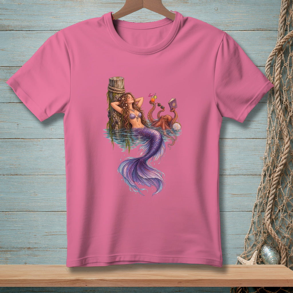 Mermaid lounging by a dock with an octopus holding drinks and a book.