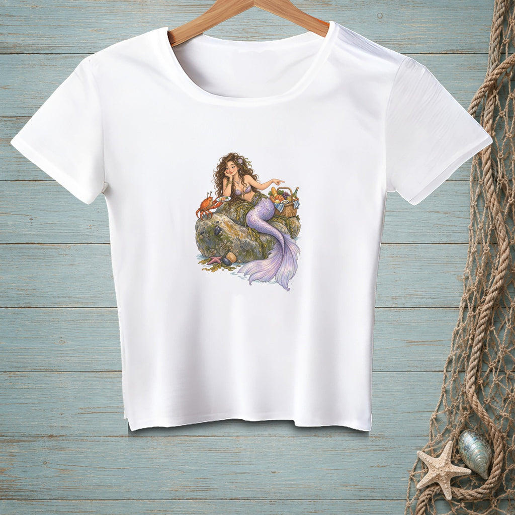White t-shirt featuring a mermaid with a crab and picnic basket.