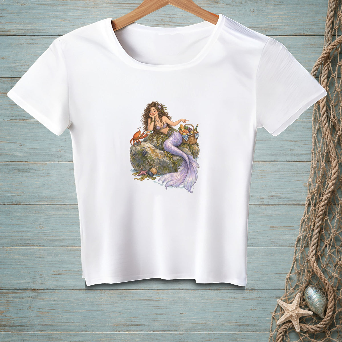 White t-shirt featuring a mermaid with a crab and picnic basket.