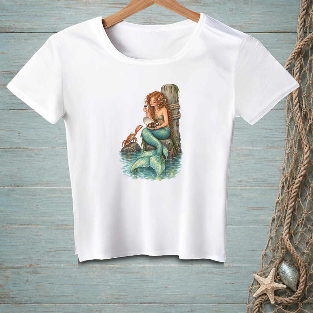 White t-shirt with a mermaid, crab, and shells design.