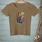 Brown t-shirt with mermaid on dock beside seagull and "Thoughts and Prayers" sign.