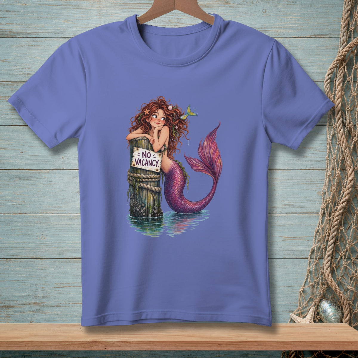 Mermaid leaning on a post with a "No Vacancy" sign in the water.