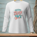 White long-sleeved shirt with "Resting Beach Face" graphic and mermaid tail.