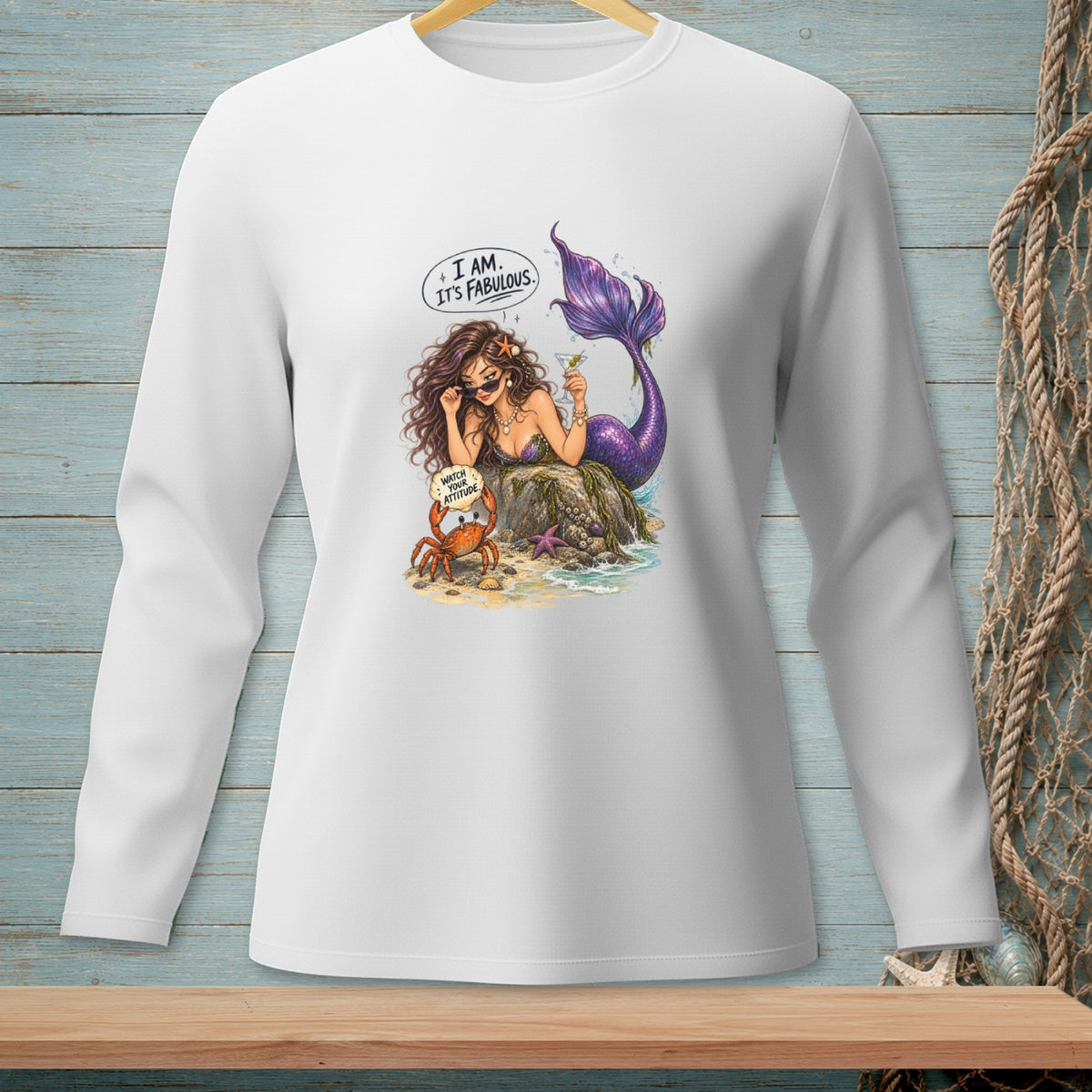 White long-sleeve shirt with a mermaid and crab graphic saying "I AM. IT'S FABULOUS."